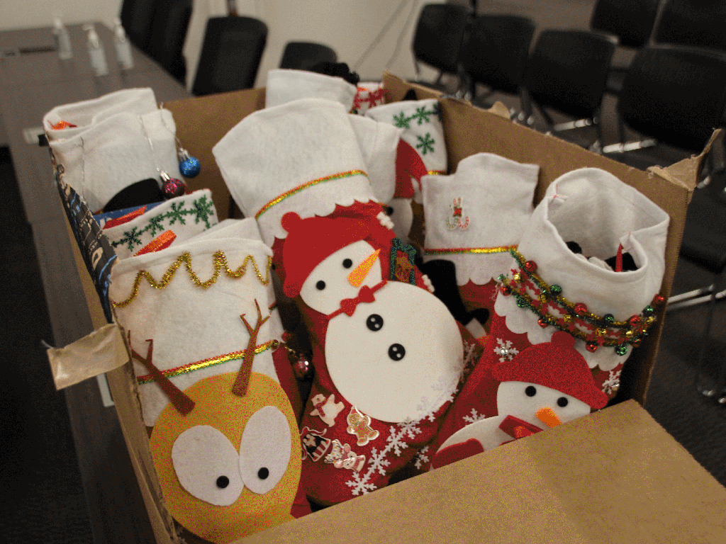 Stockings full of gifts, toys and food for families with children to receive during food distributions.