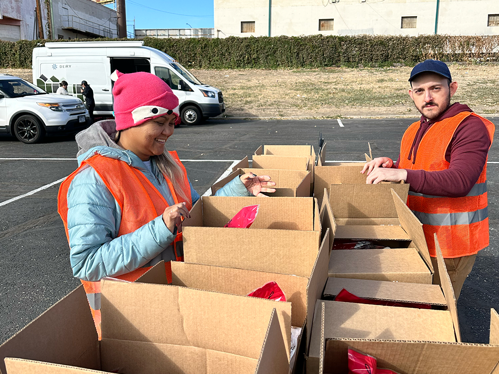 Helping distribute 150 food boxes to families in need at Mile High Stadium.