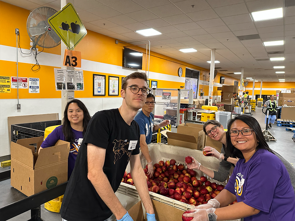 Packing boxes of apples with Second Harvest of Silicon Valley.