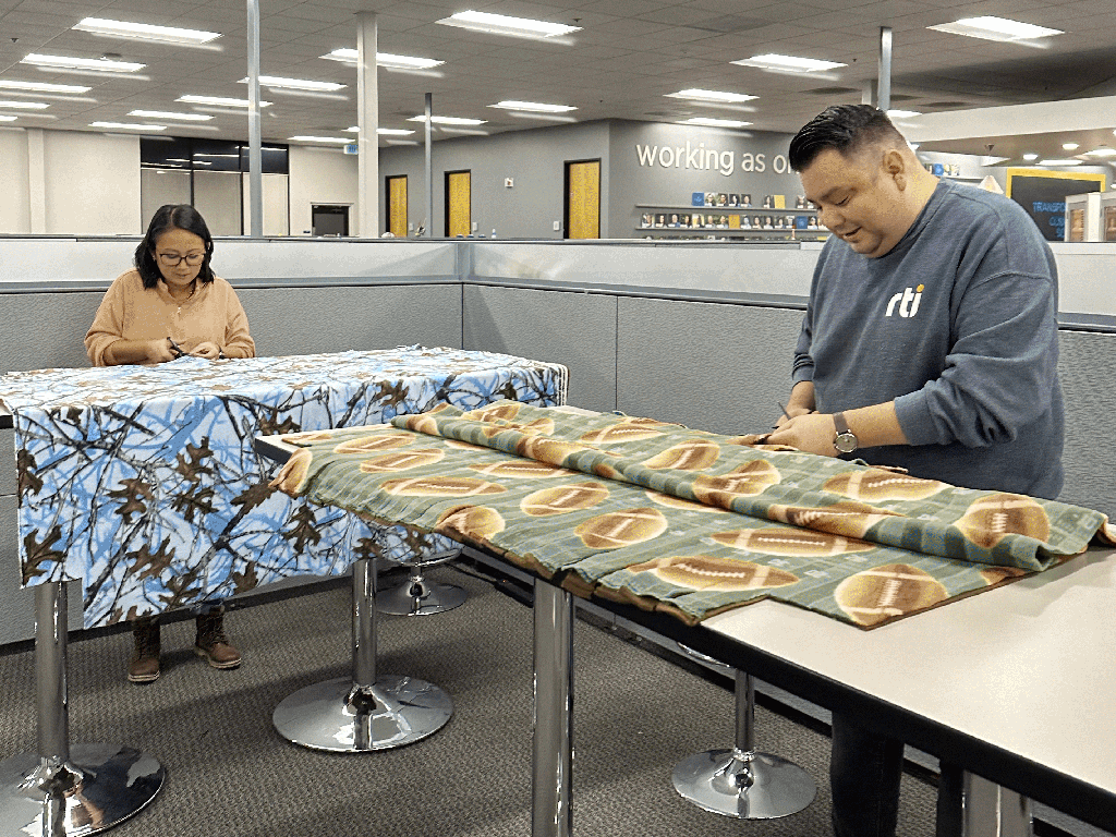 Cutting and making blankets for Project Linus.