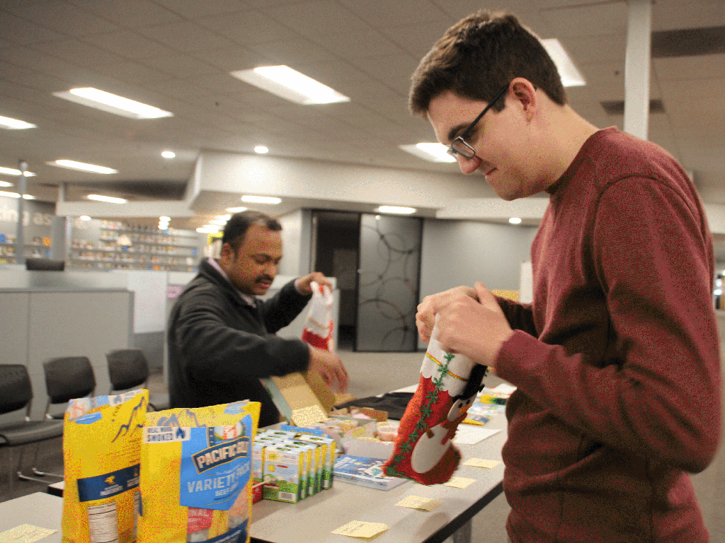 Packing foods and gifts for families with children during their drive-through food distributions.